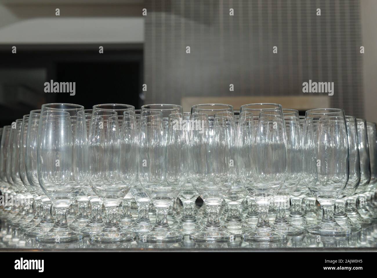 Empty and aligned crystal bowls over black granite. Stock Photo