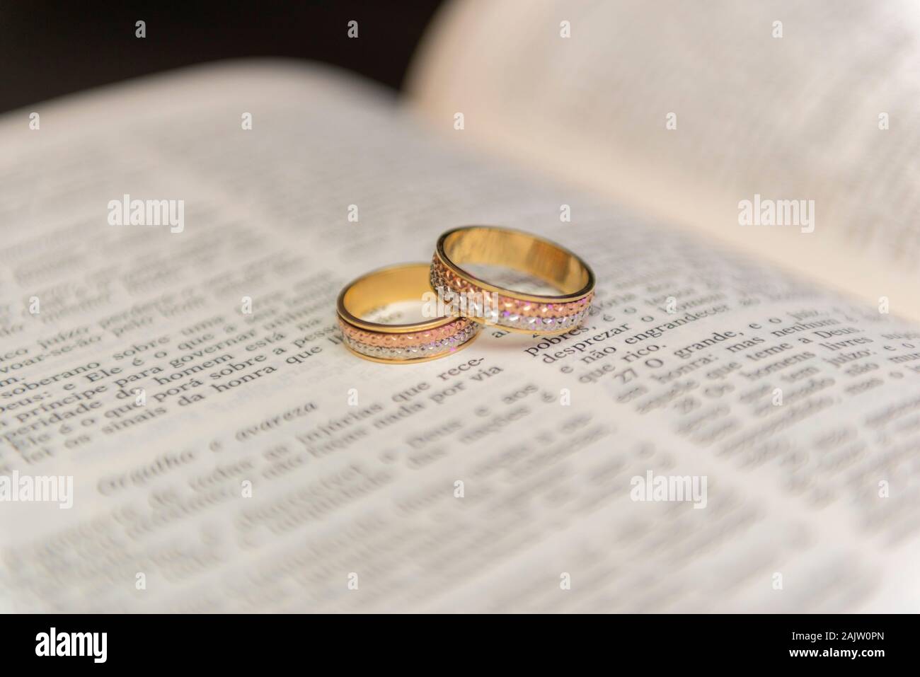 Wedding rings on a holy bible "Bíblia Sagrada". Concept of union, love