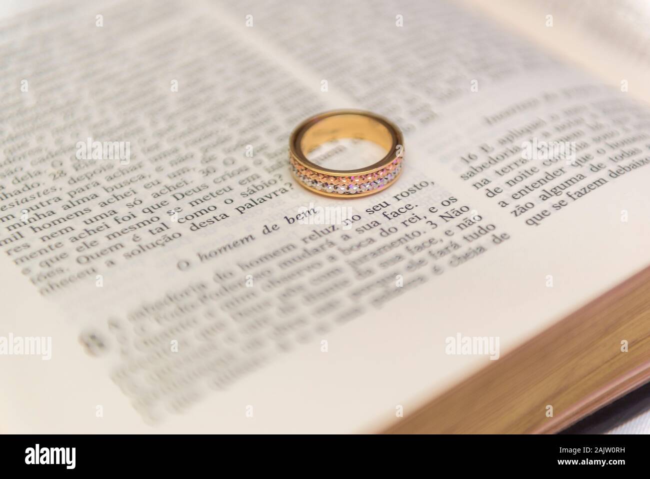 Wedding rings on a open holy bible "Bíblia Sagrada". Concept of union