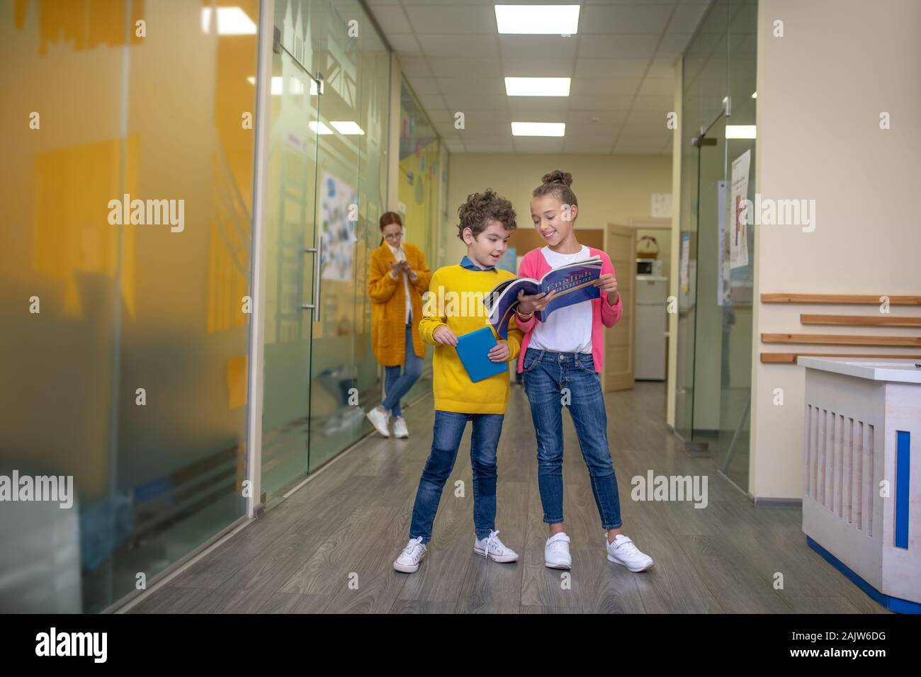 Two classmates doing their homework during the break Stock Photo - Alamy