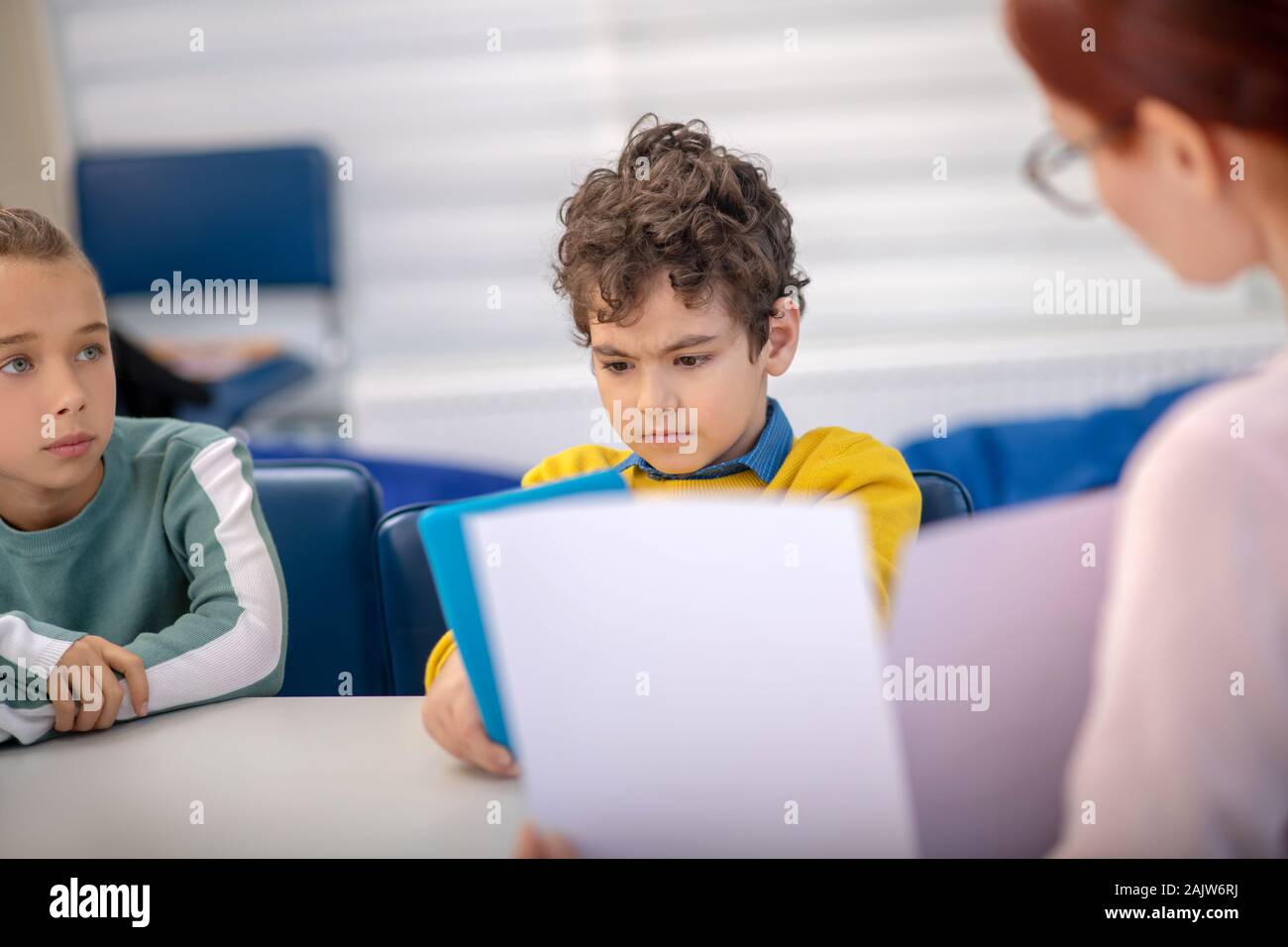 Teacher working with problematic children in her class Stock Photo