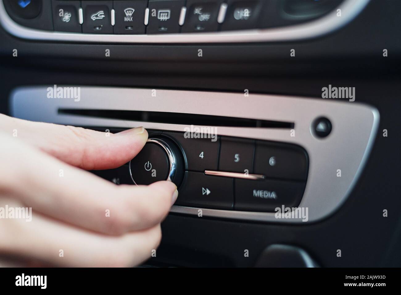 Hand press on button on car radio, close up Stock Photo - Alamy