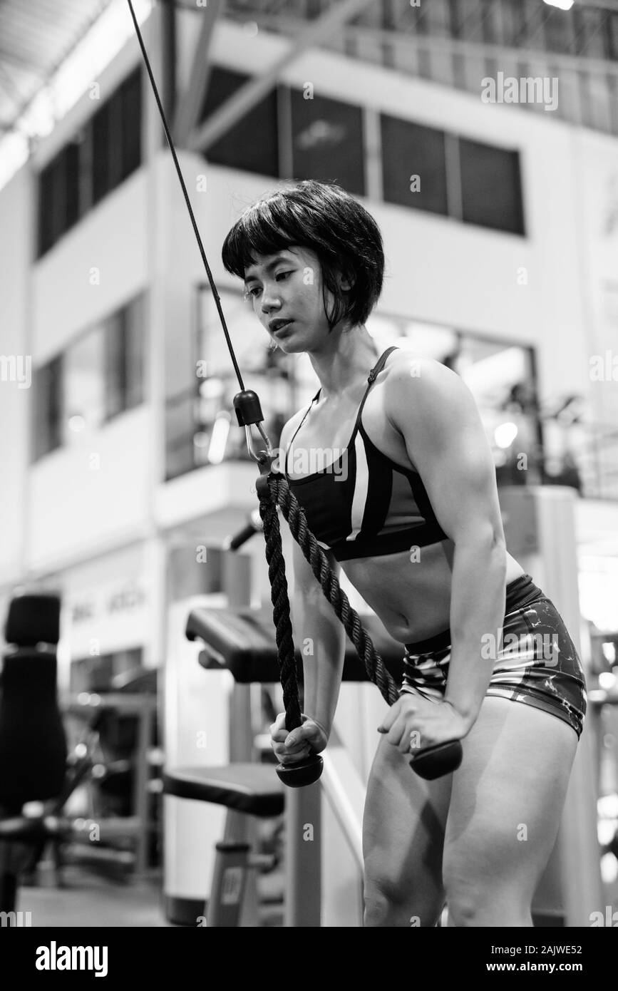 Young beautiful Asian woman working out at the gym Stock Photo