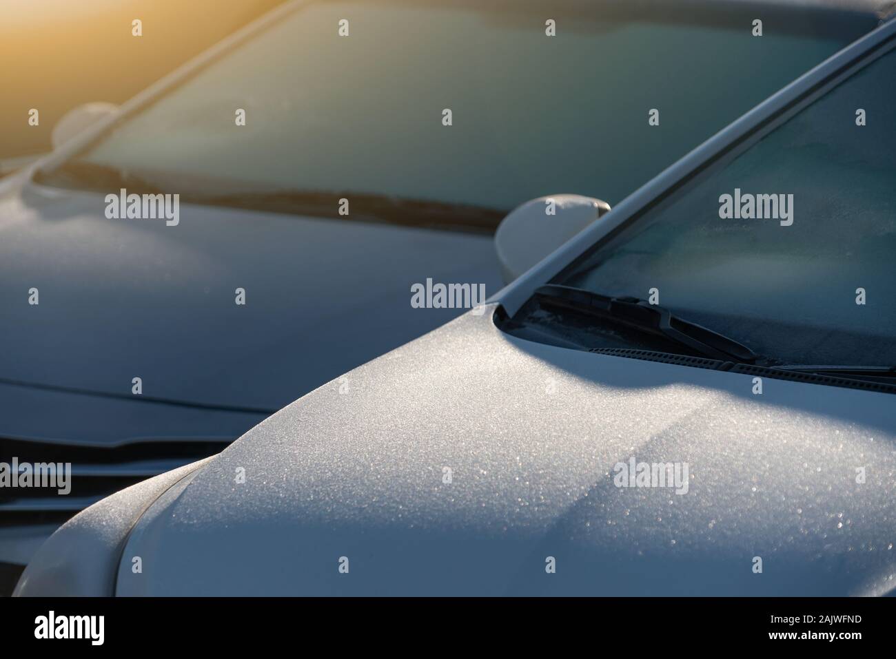 Parked cars with hoarfrost on the windshield Stock Photo
