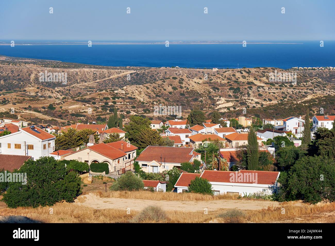 The view of cosy residential houses of Pissouri village on the side of a green hill. Limassol district. Cyprus Stock Photo