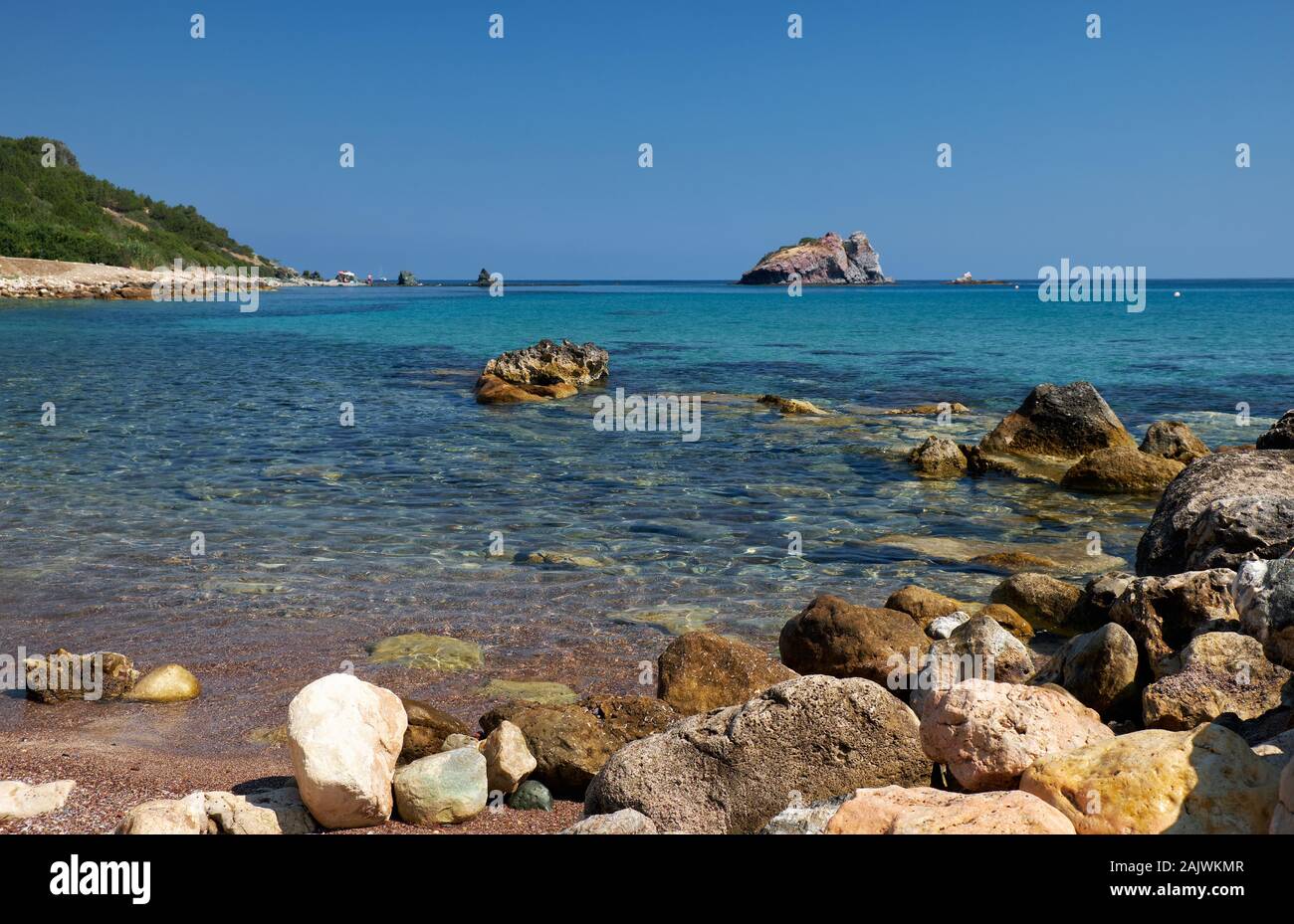 The view of the blue Takkas bay with large volcanic rock of Aphrodite near Baths of Aphrodite on the  Akamas Peninsula.  Cyprus Stock Photo