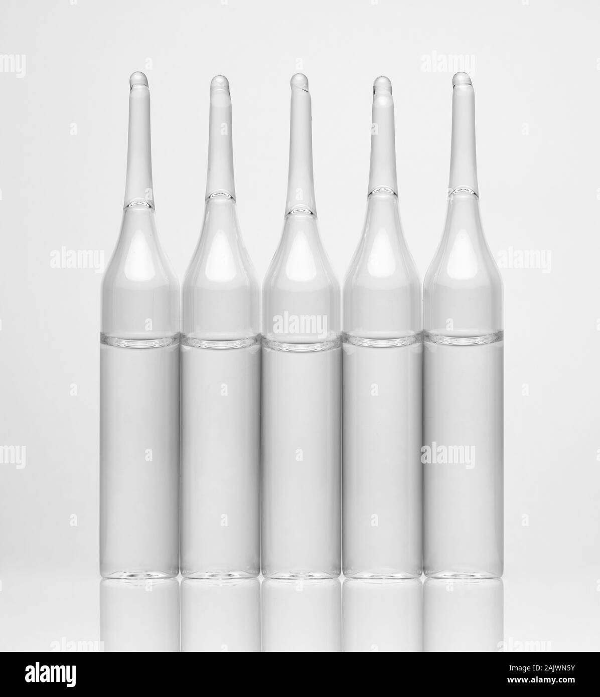 Ampoules. Transparent capsules with liquid on white background