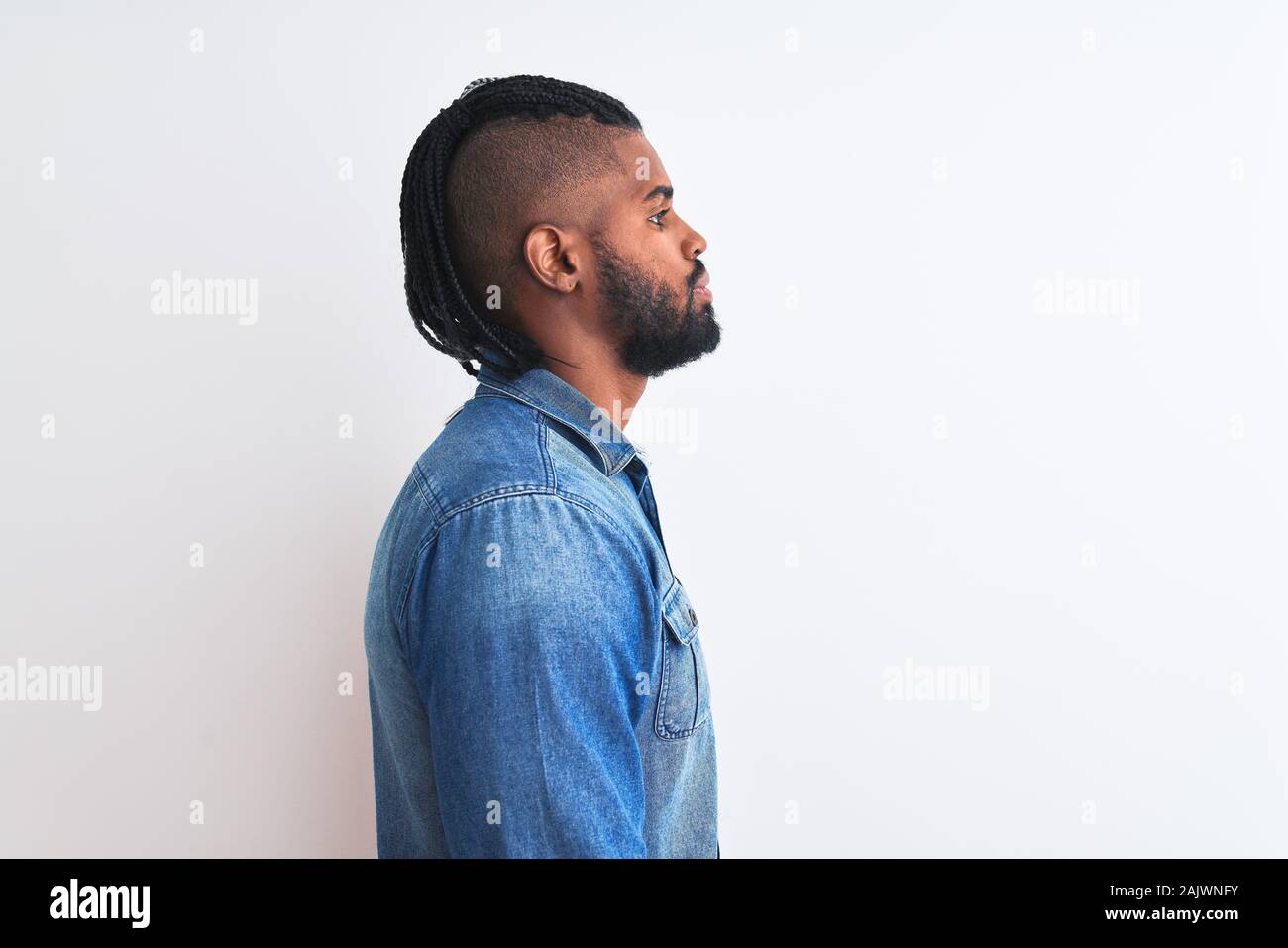 African american man with braids wearing denim shirt over isolated ...
