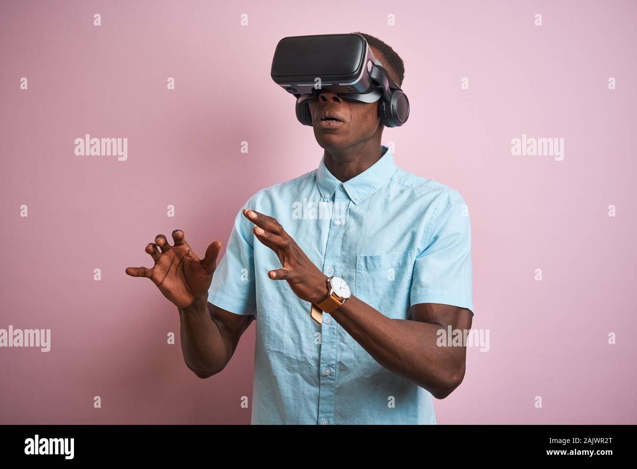 Young african american man playing virtual reality game using goggles ...