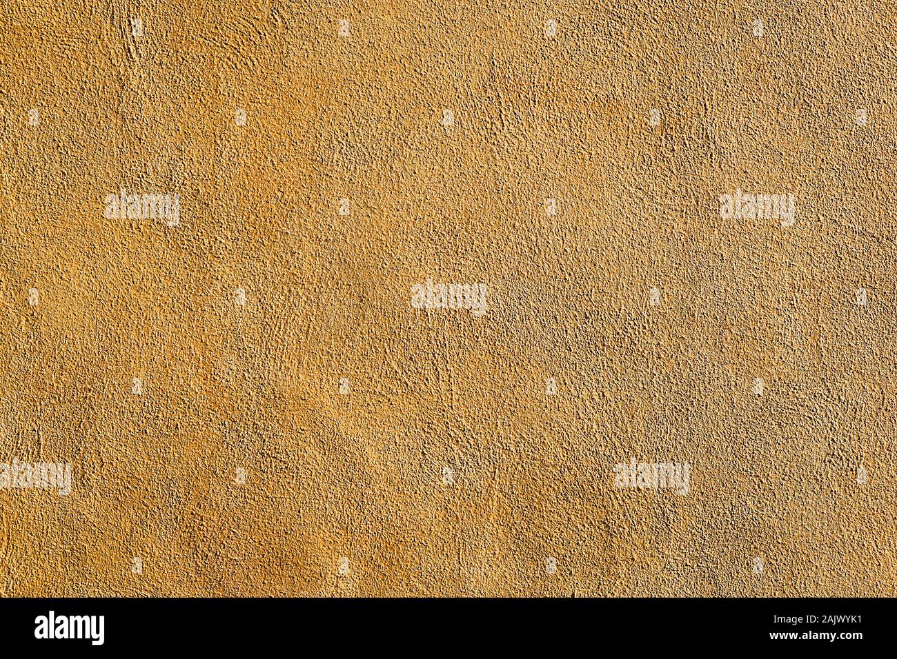 Background from a wall of ocre plaster Stock Photo