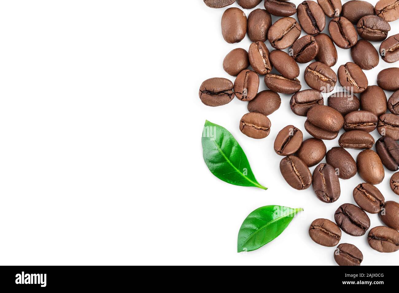 Heap of roasted coffee beans with leaves isolated on white background ...
