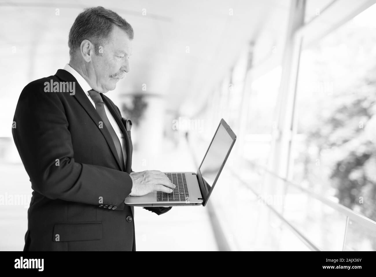 Handsome senior businessman with mustache exploring the city Stock Photo