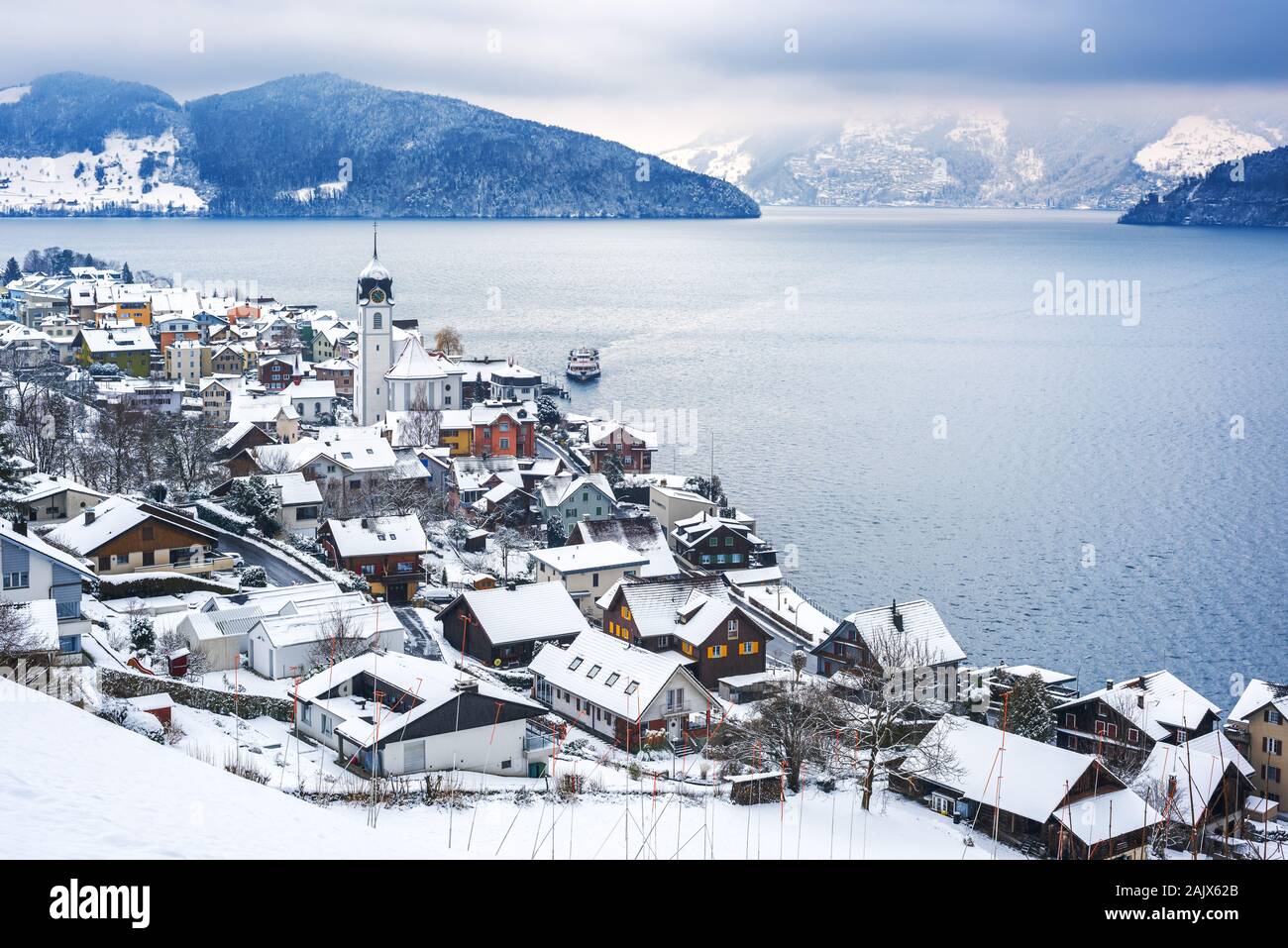 Lake Lucerne, Switzerland, view of Beckenried village and Alps mountains covered with white snow at winter timer Stock Photo