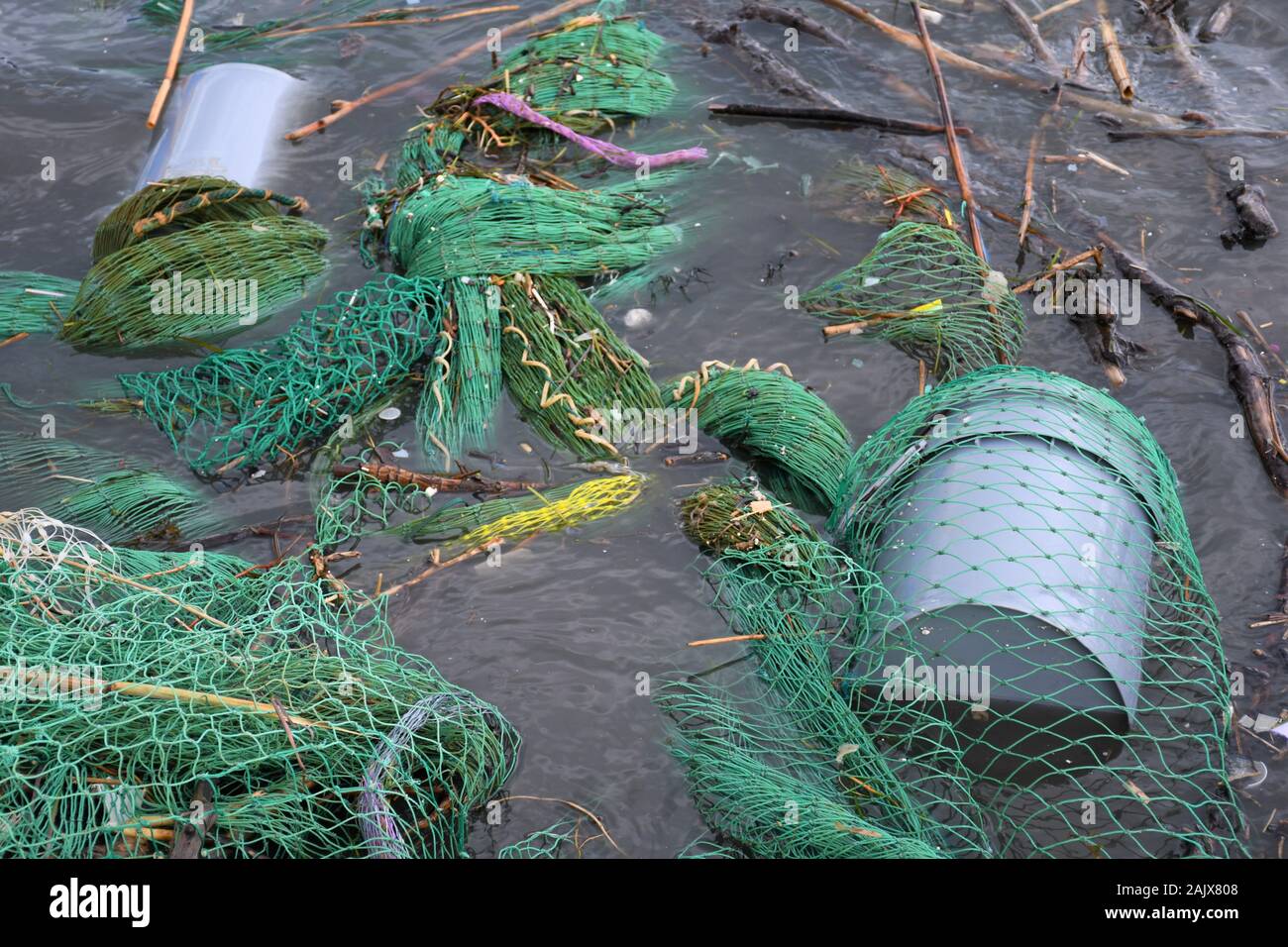 Plastic and microplastic waste and garbage floating in the water with
