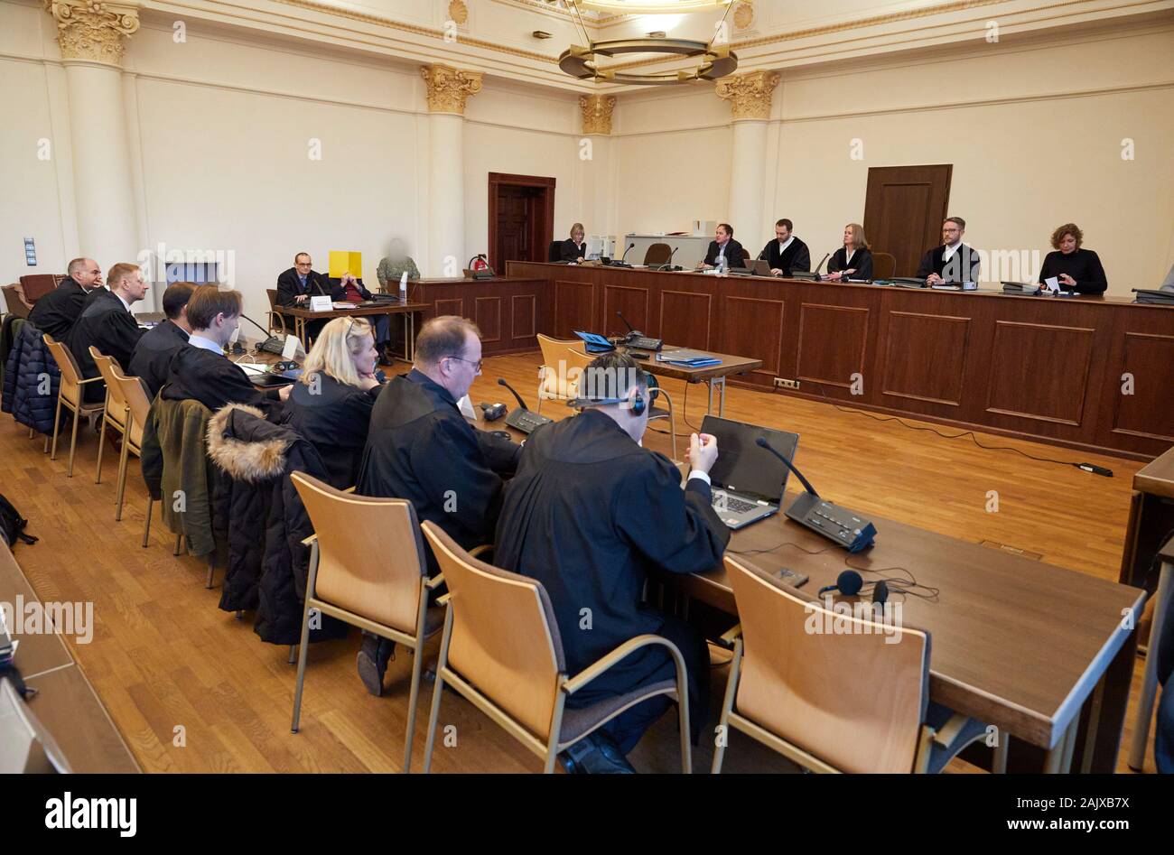 06 January 2020, Hamburg: The defendant (behind yellow folder), his
