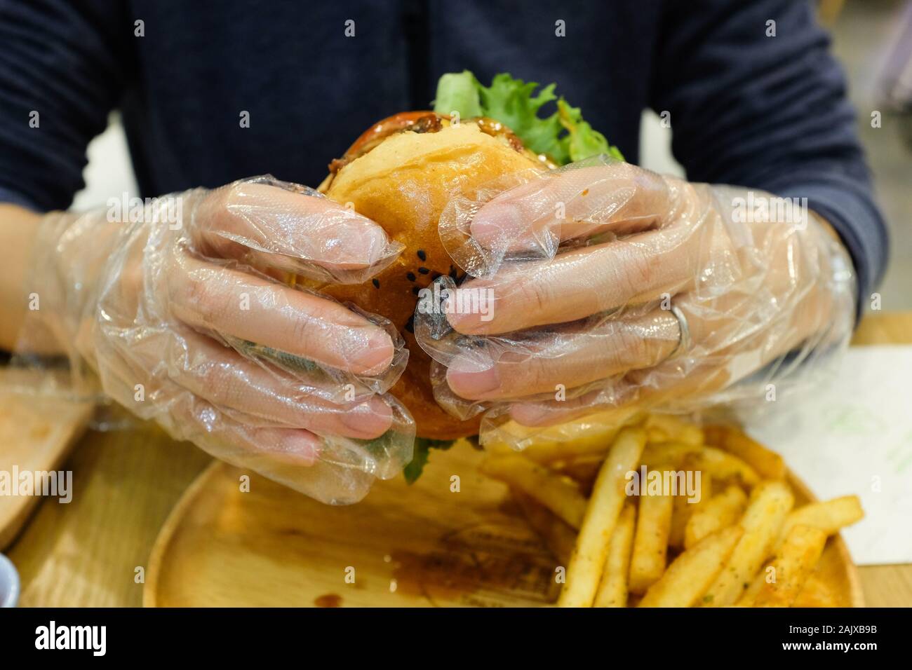 Clear plastic gloves offered to diners at a hamburger restaurant in Xiamen (Amoy), China. Stock Photo