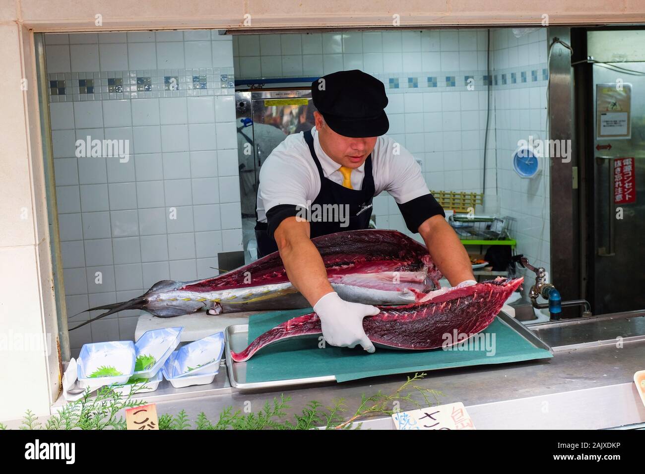 A man prepares a tuna fish for sale at Daimaru department store in Kyoto, Japan. Stock Photo