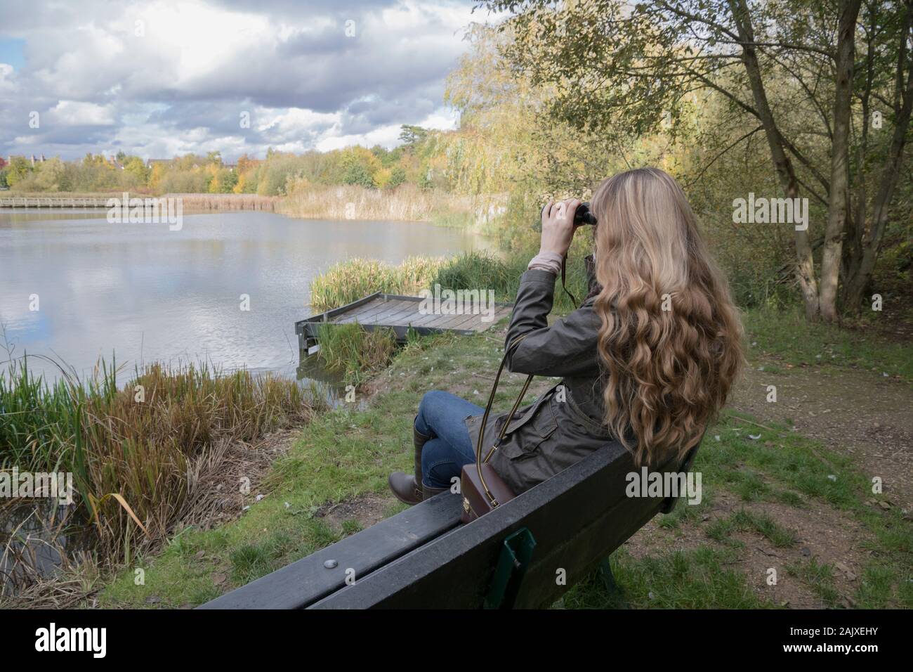 Lady bird watching using binoculars Stock Photo Alamy