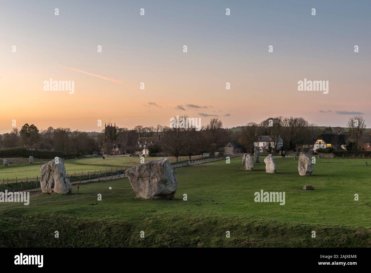 Avebury, Wiltshire, a vast Neolithic henge monument built around 3000 BC. The two portal stones and part of the inner circle with the village beyond Stock Photo