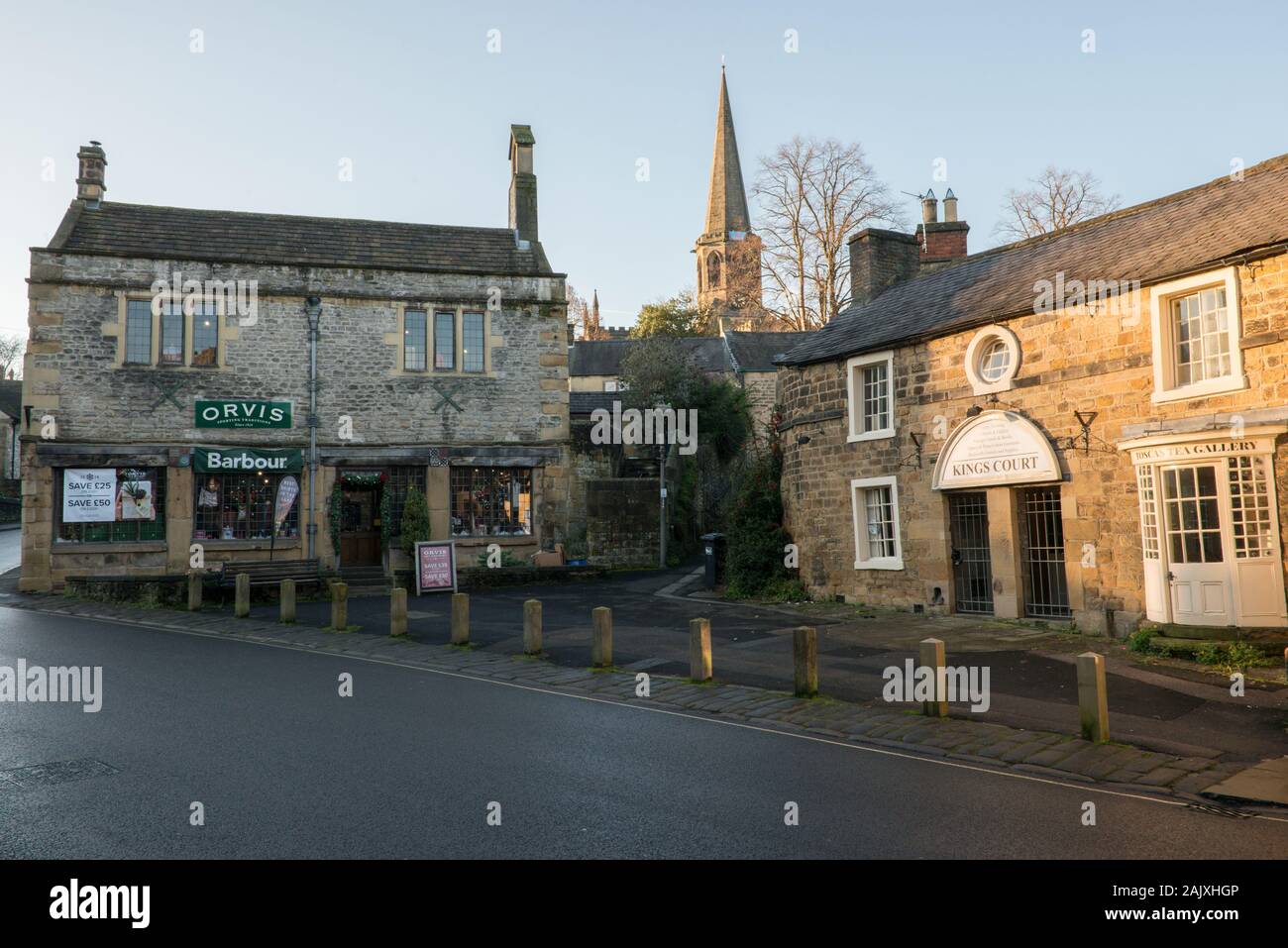 Church Street, Bakewell, Derbyshire  with Orvis Country Sports clothing and Kings Court Tea rooms with All Saints Parish Church in the background. Stock Photo