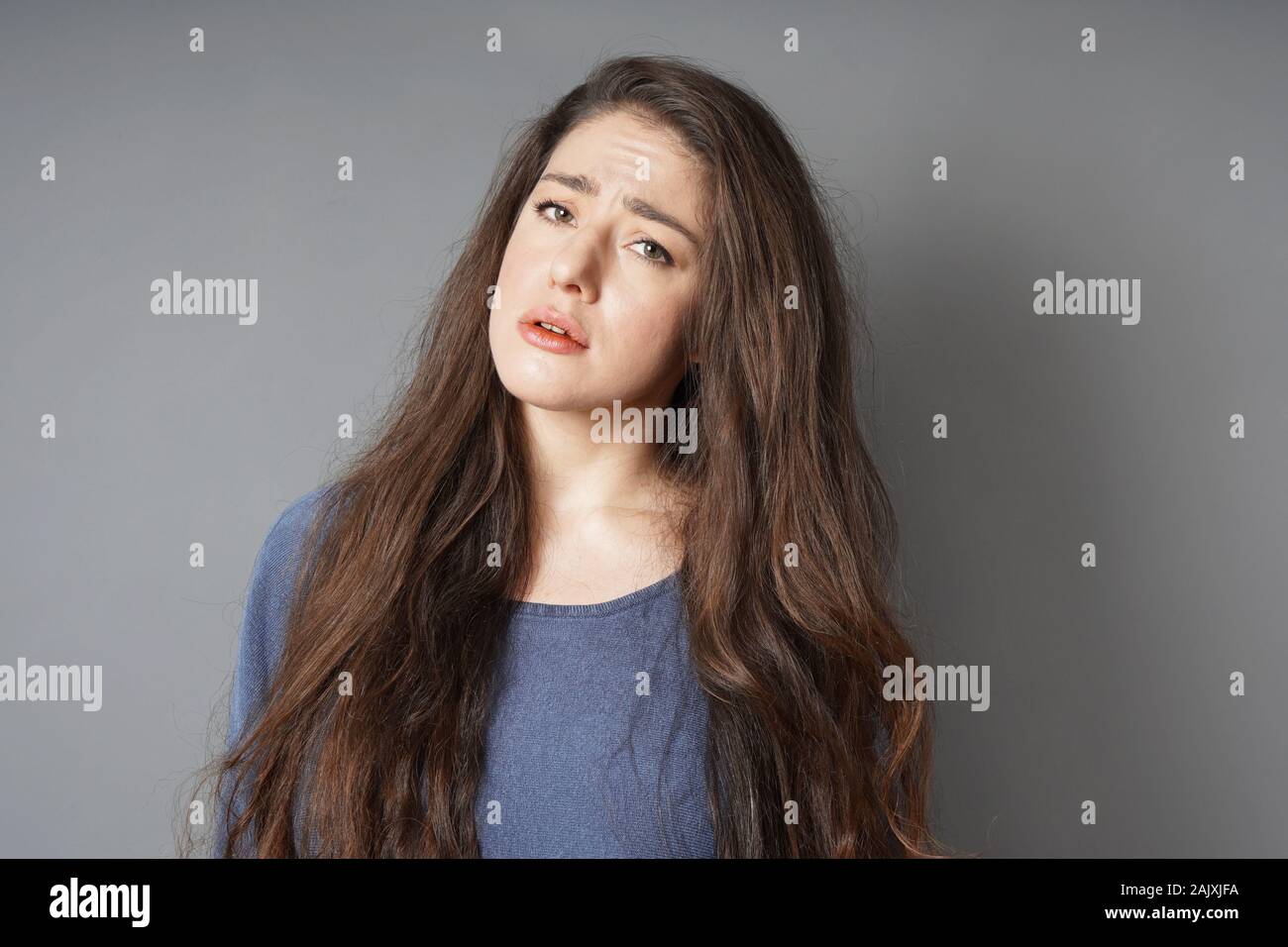 unhappy sad young woman worried and frowning Stock Photo