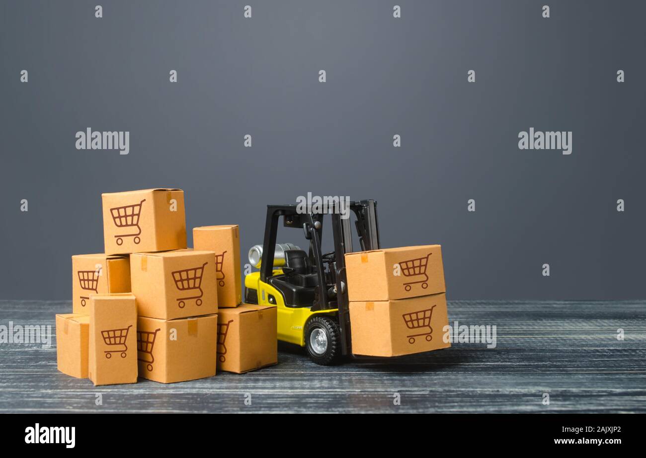 Yellow Forklift truck and boxes of goods. Transportation logistics infrastructure, import and export products delivery. Production, transport, cargo s Stock Photo