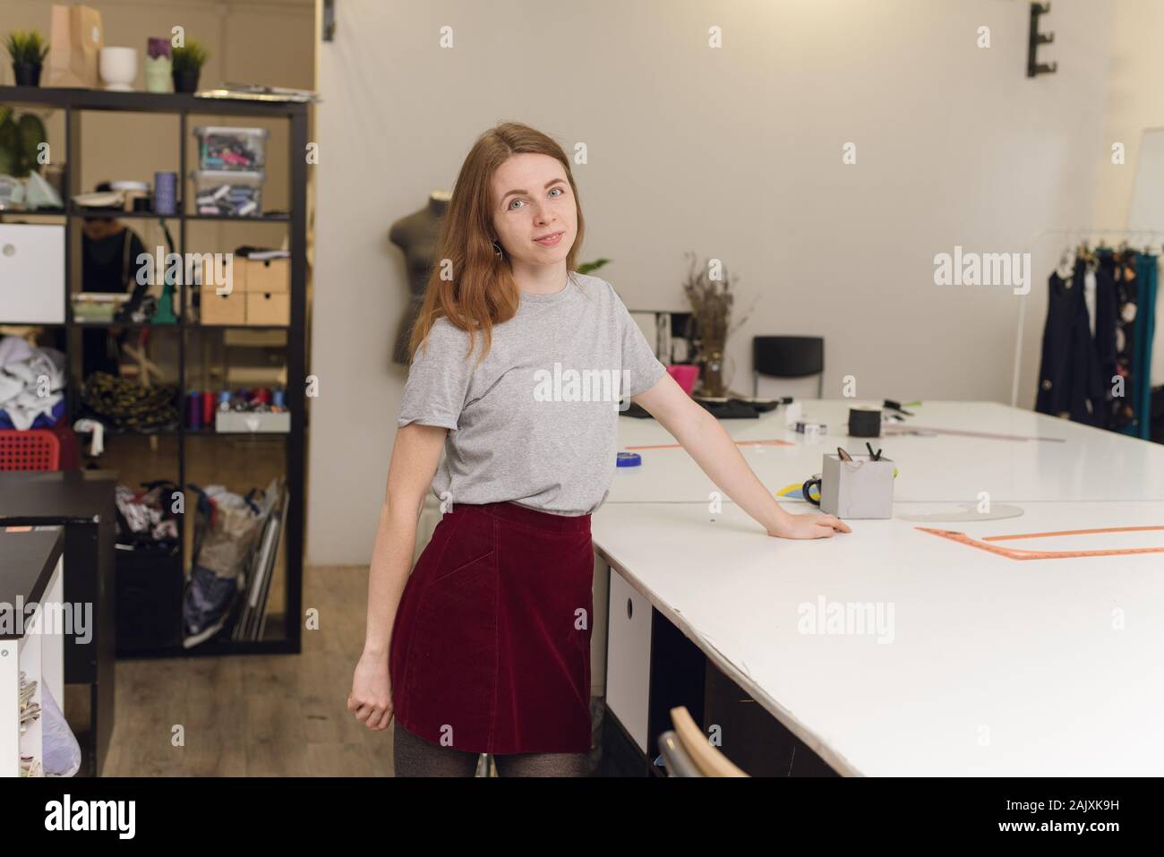 https://c8.alamy.com/comp/2AJXK9H/a-happy-seamstress-in-a-sewing-studio-looking-at-camera-portrait-of-a-beautiful-seamstress-carrying-a-tape-measure-and-working-in-a-textile-factory-2AJXK9H.jpg