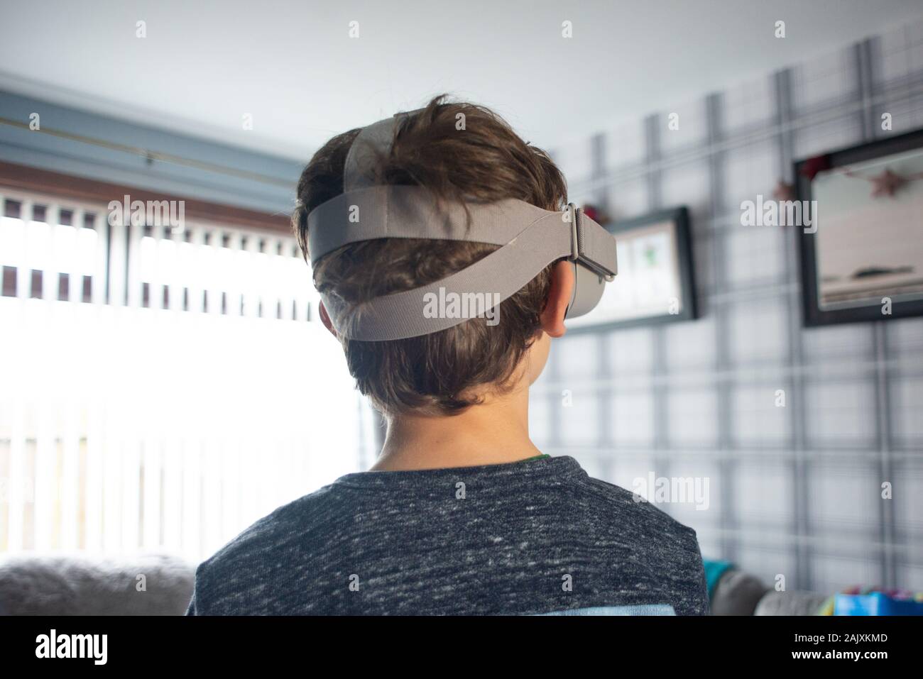 Boy in his livingroom wearing a Oculus Go VR headset Stock Photo