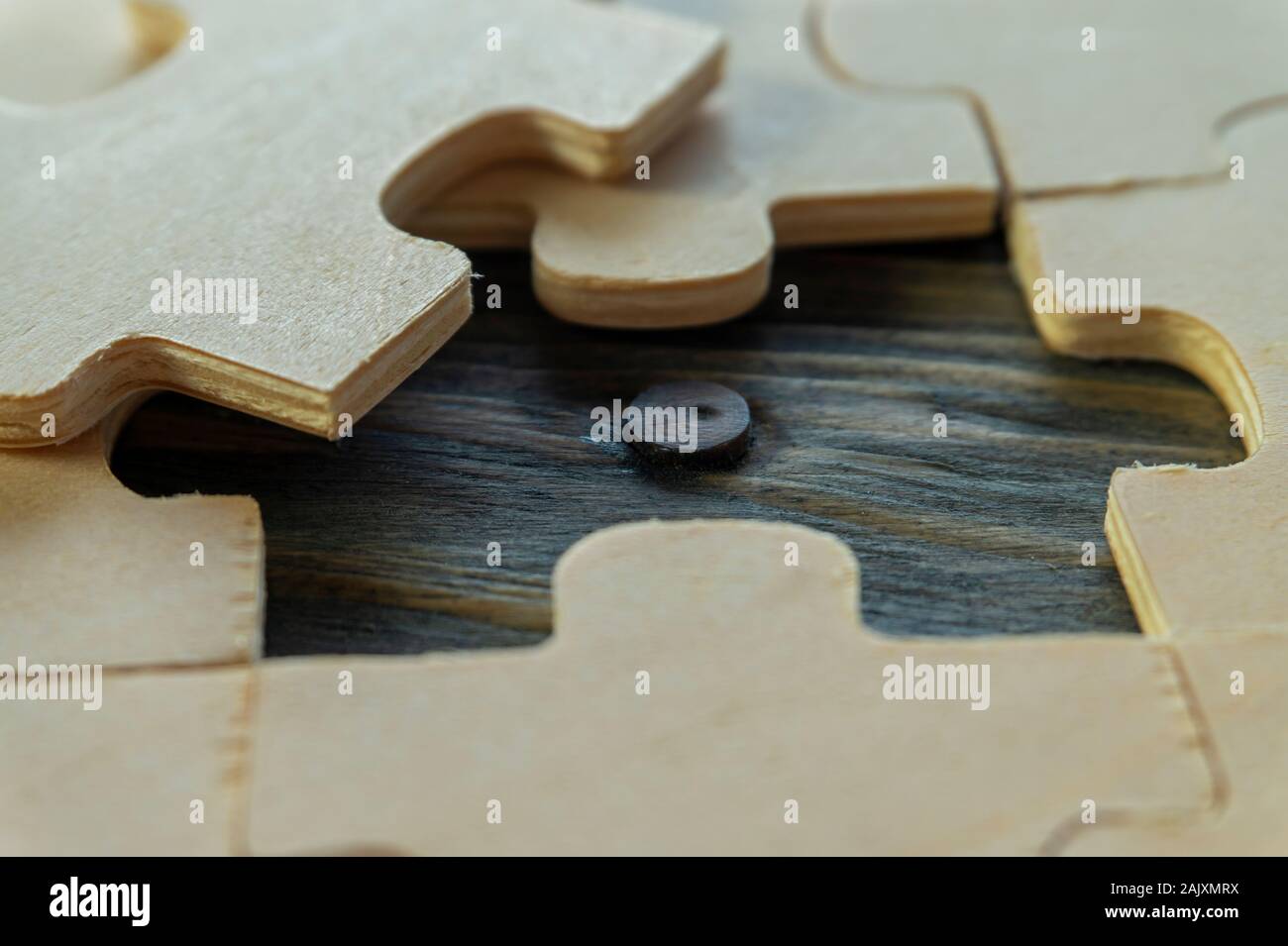 Close-up on unpainted plywood puzzles with one piece taken out, showing  wooden surface underneath, problem solving and teamwork concept Stock Photo  - Alamy