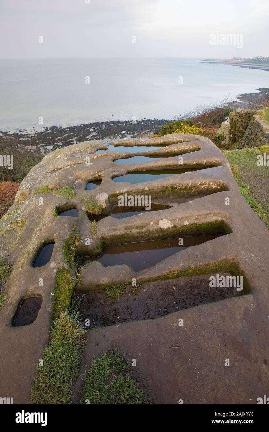 Stone tombs in winter that have been cut out of solid rock near to St Patrick’s Chapel close to the village of Heysham and Throbshaw, or Throbshire, P Stock Photo