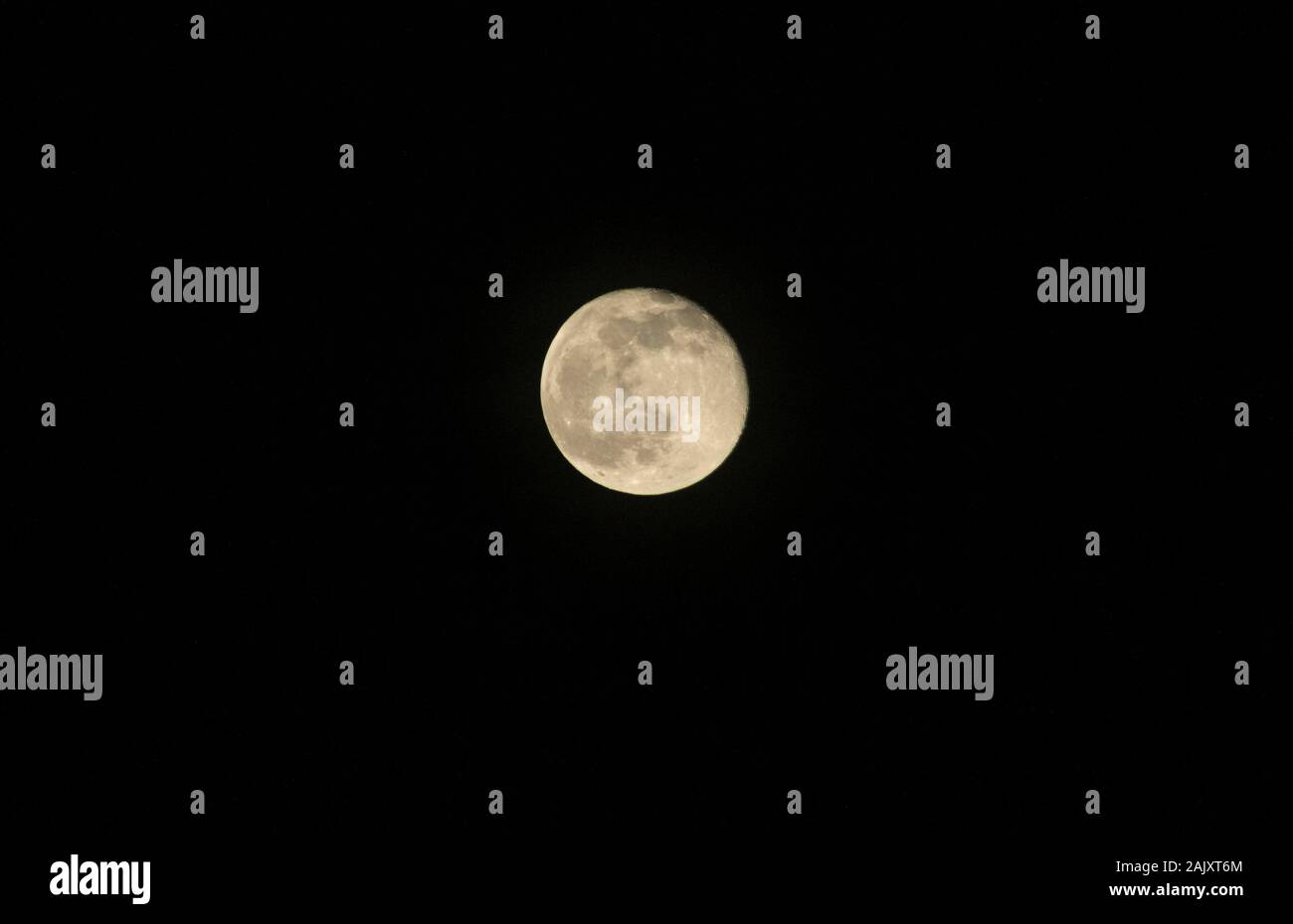 Near full moon in the night sky Stock Photo Alamy