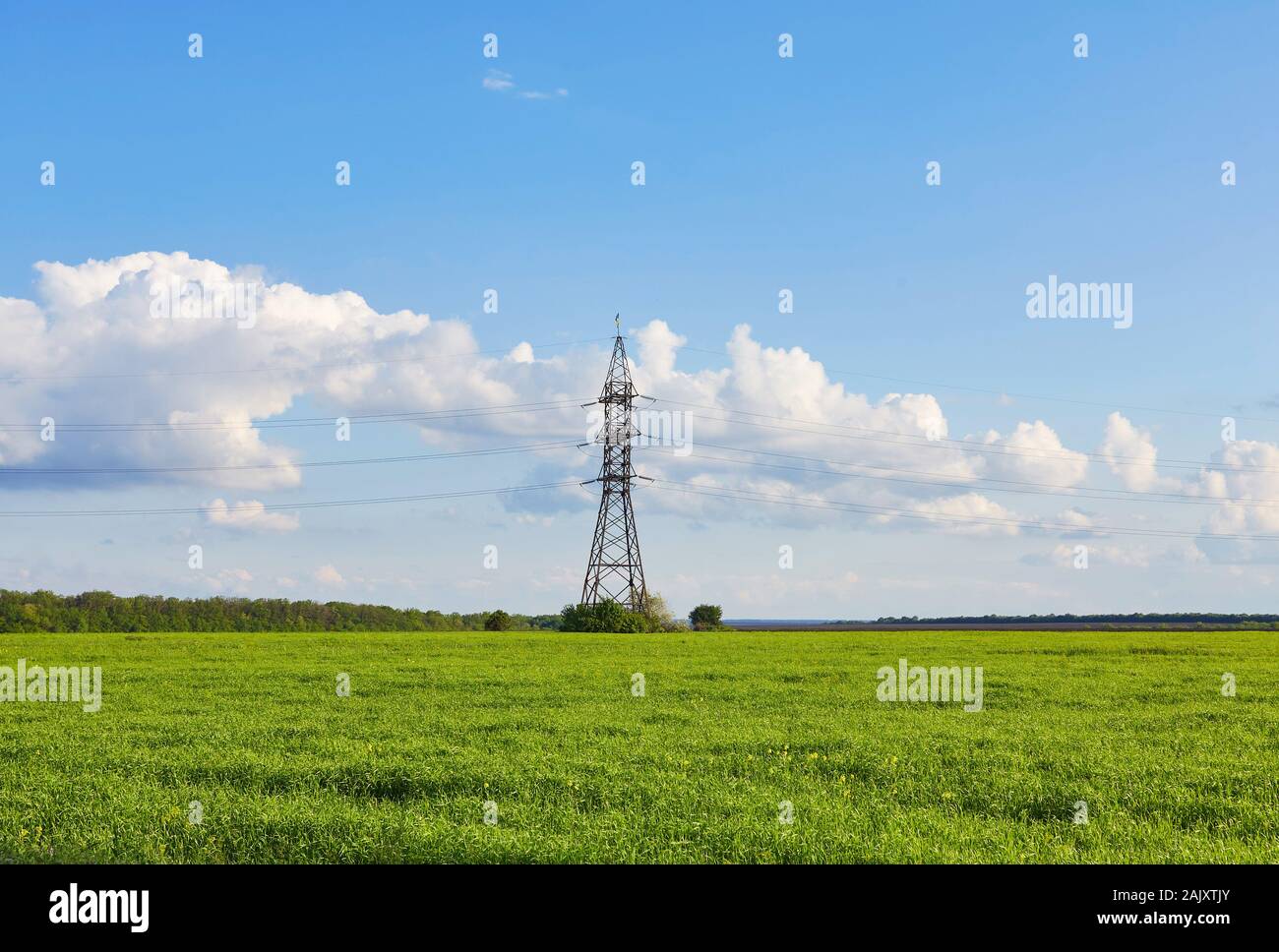 High voltage Pole against blue sky and white clouds Stock Photo - Alamy
