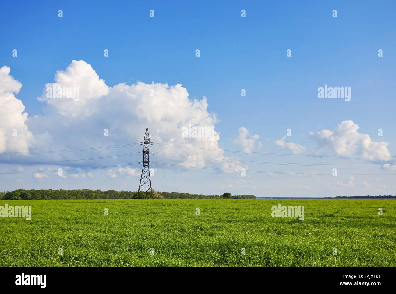 High voltage Pole against blue sky and white clouds Stock Photo - Alamy