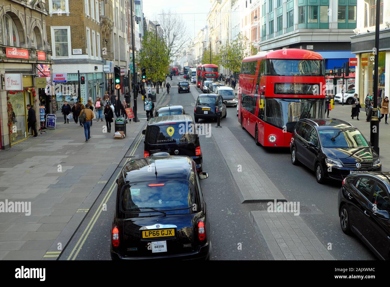 View of taxis, buses, traffic and people walking along on Oxford Street  in West London W1 England Great Britain UK  KATHY DEWITT Stock Photo