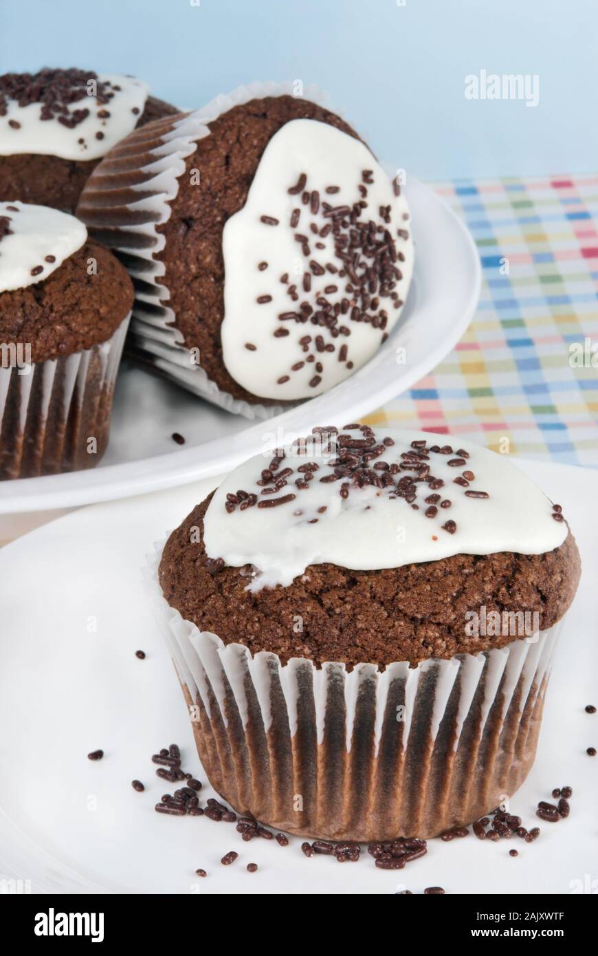 Homemade jumbo sized dark chocolate cupcakes with white buttercream icing and chocolate