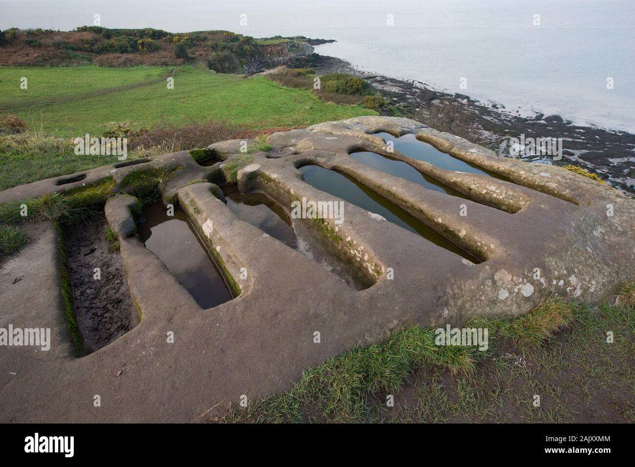 Stone tombs in winter that have been cut out of solid rock near to St Patrick’s Chapel close to the village of Heysham and Throbshaw, or Throbshire, P Stock Photo