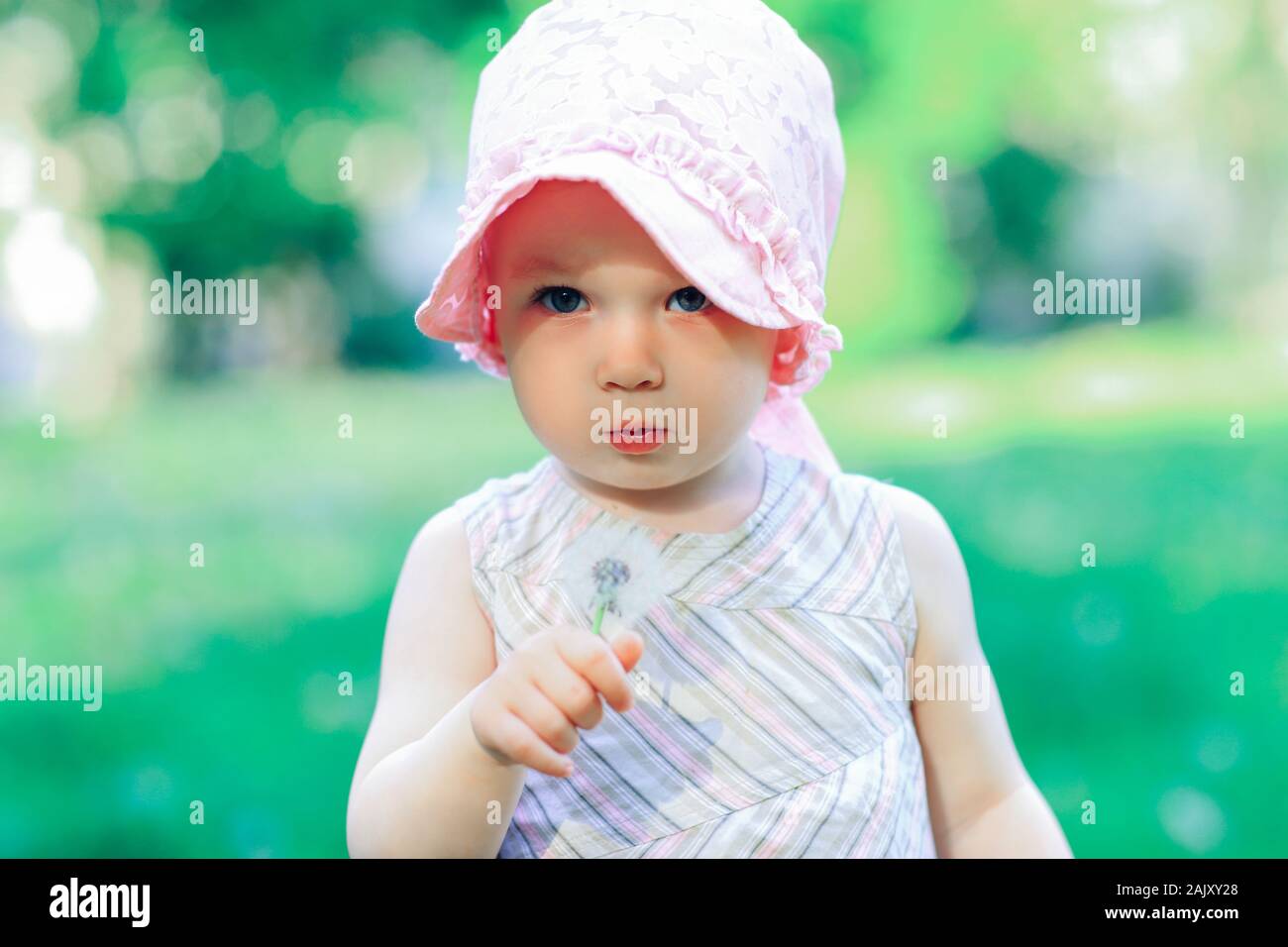 portrait of a pretty little girl with a dandelion Stock Photo - Alamy