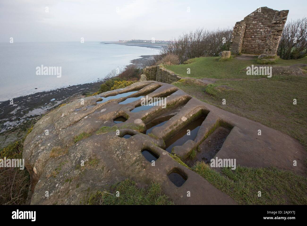 Stone tombs in winter that have been cut out of solid rock near to St Patrick’s Chapel close to the village of Heysham and Throbshaw, or Throbshire, P Stock Photo