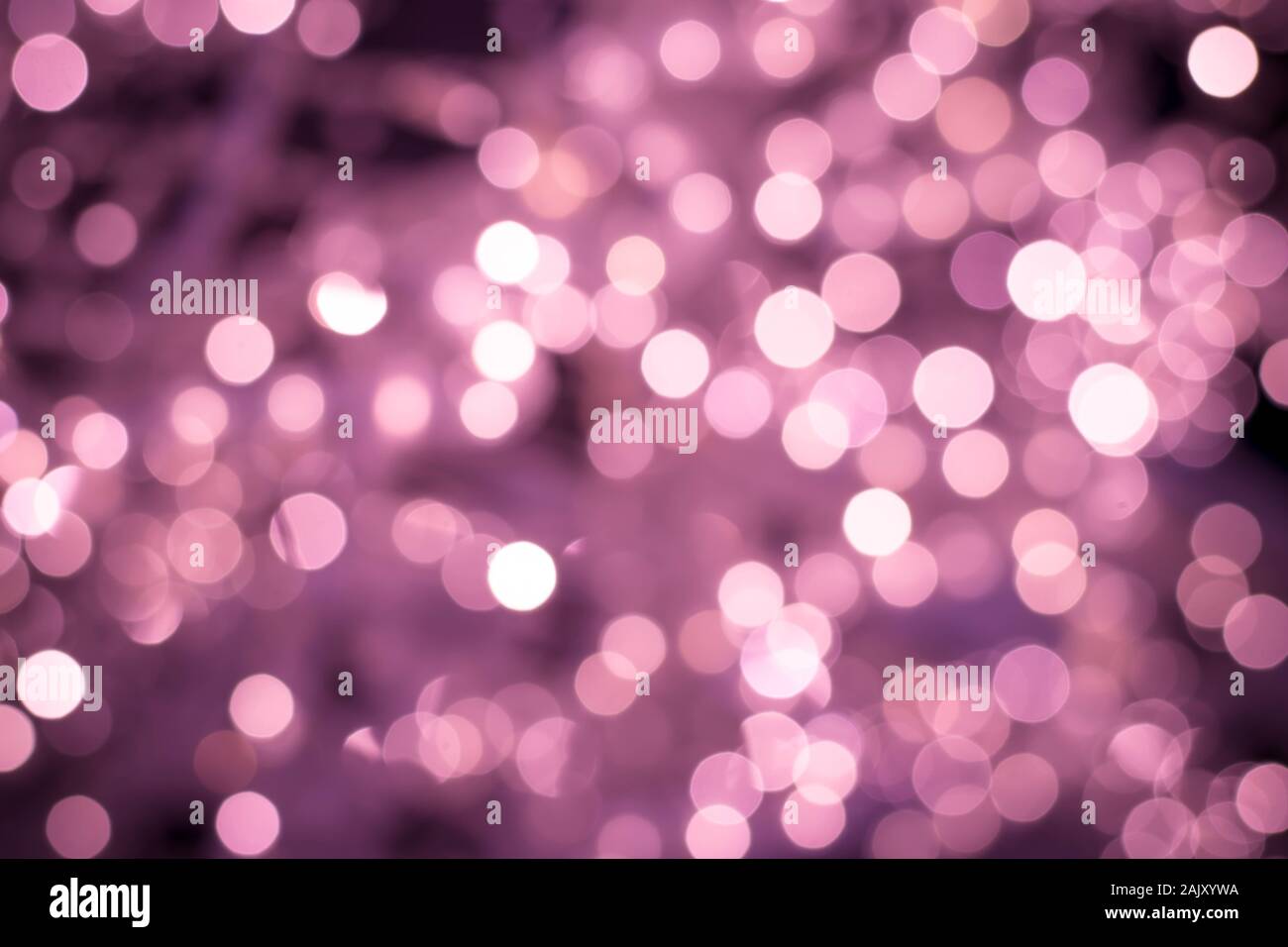 Blurred pink backdrop, night bokeh lights texture, defocused background. Illuminated blurry backgrounds with shiny circles Stock Photo