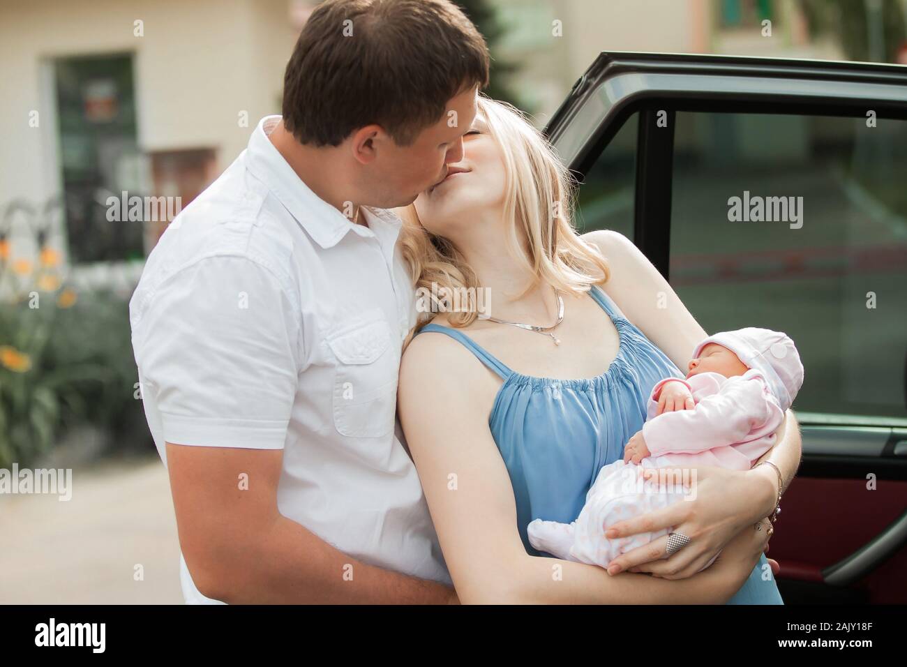 happy man kissing his wife with newborn baby Stock Photo - Alamy