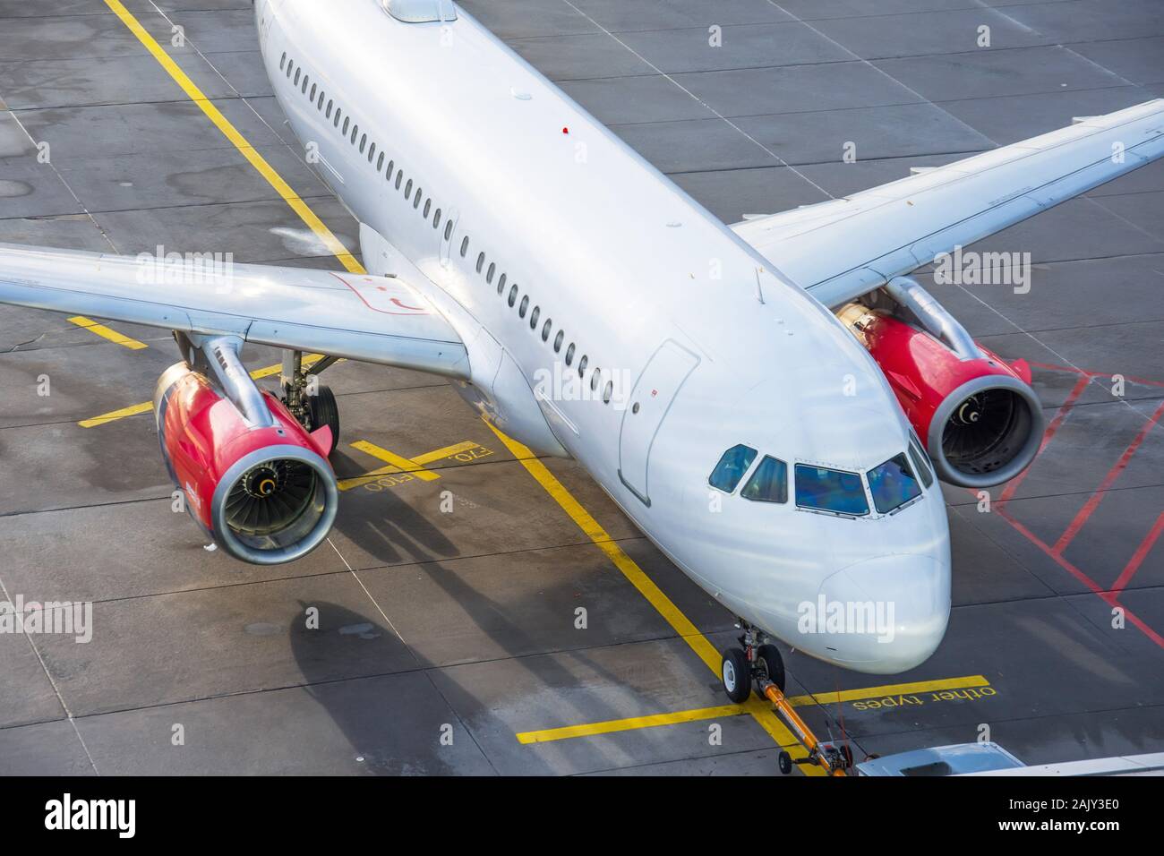 Commercial airplane parking at the airport sunlit, top view Stock Photo ...