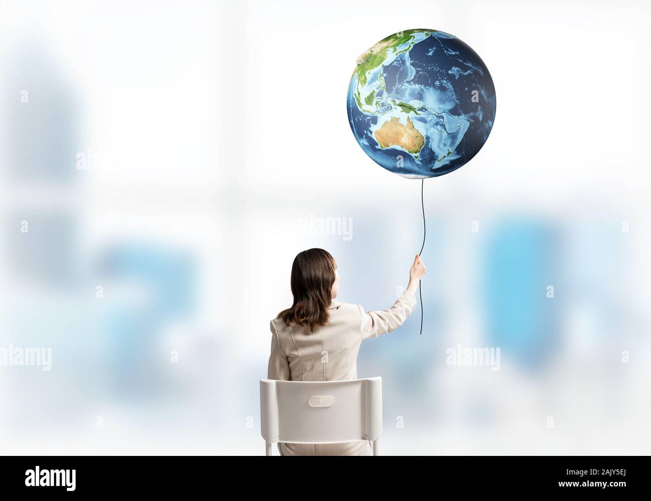 Woman holding by rope earth globe Stock Photo - Alamy
