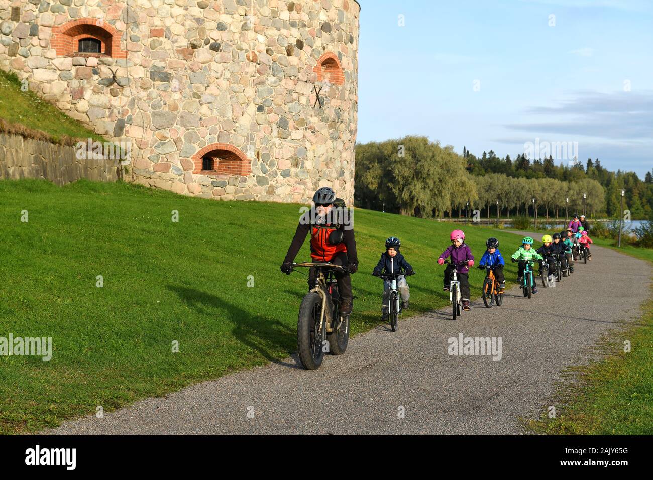 Little kids on bicycles. Excursion in nature. Hameenlinna, Suomi Stock Photo