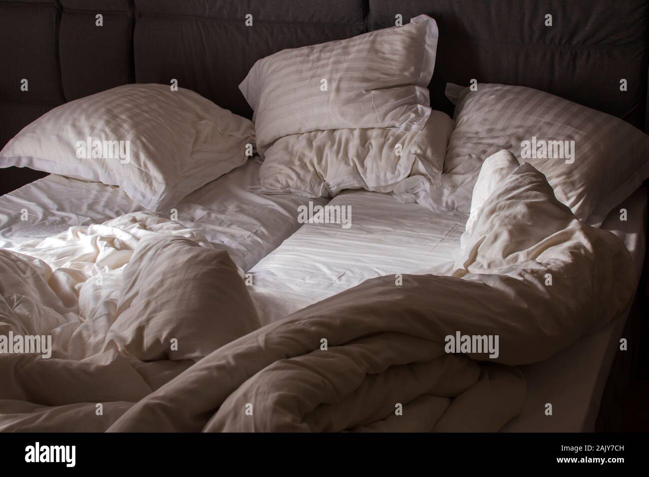 Bed sheet pillows and blanket messed up in the morning Stock Photo Alamy