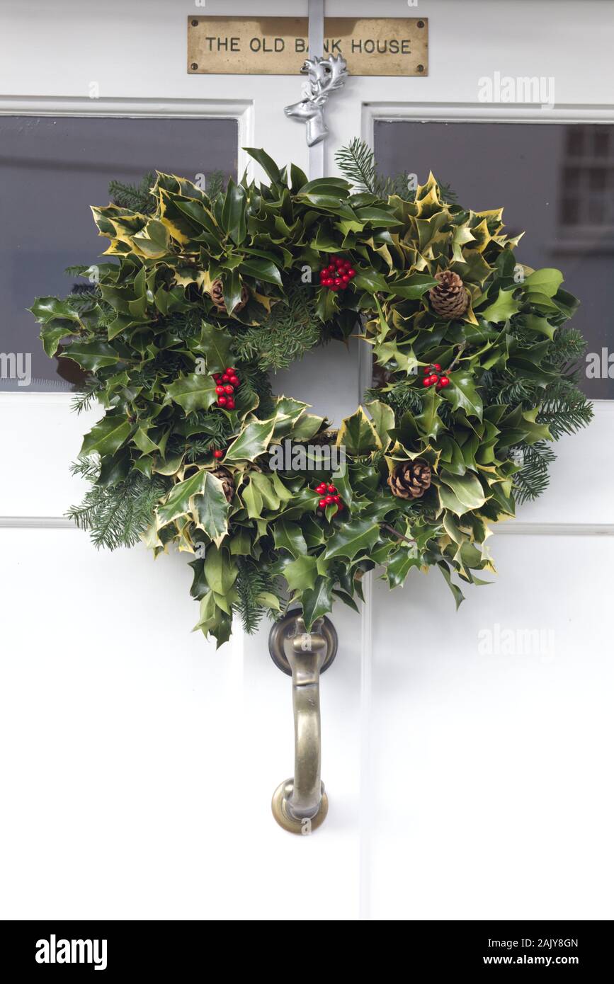 holly wreath on the door of the old bank house Stock Photo