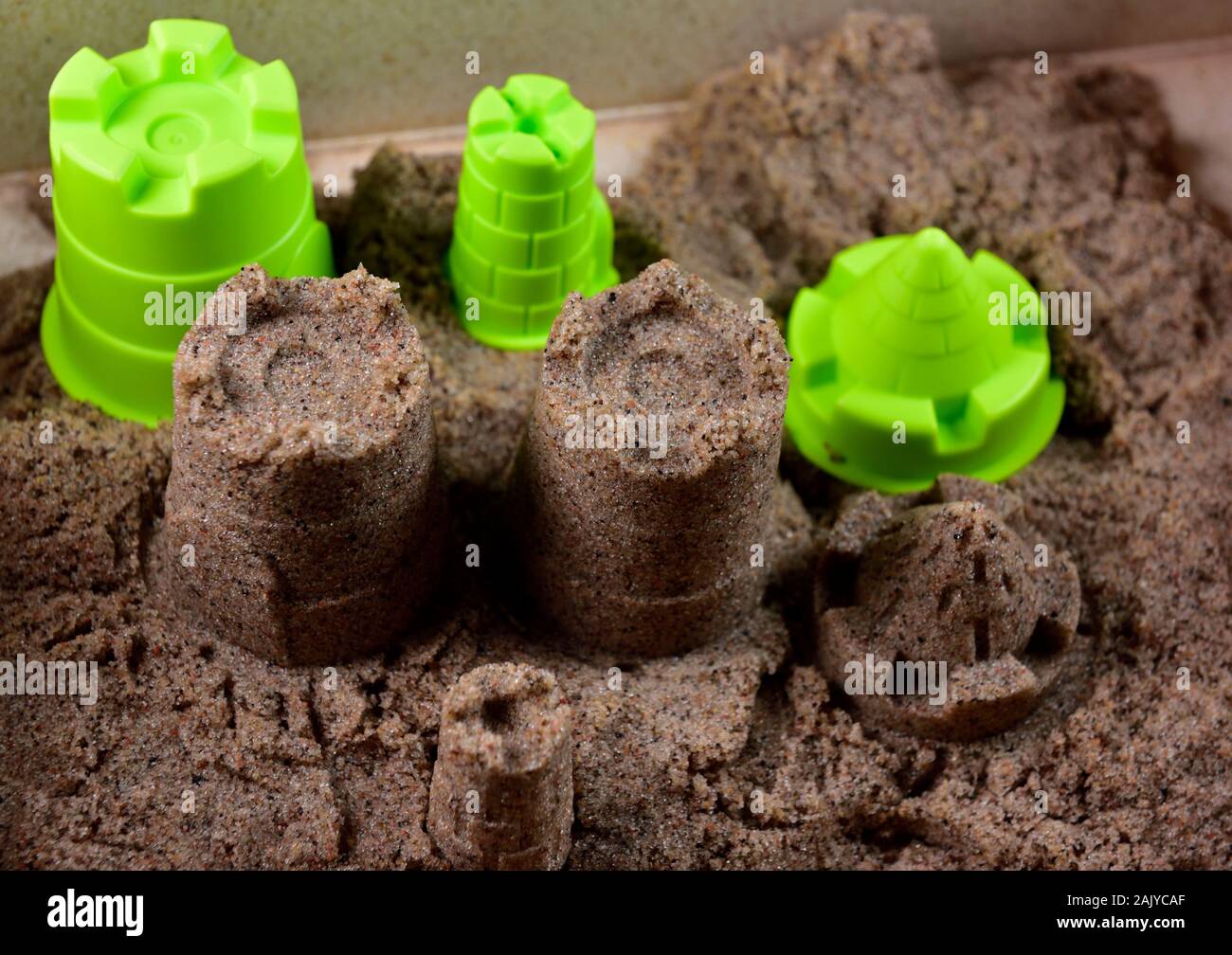 Kinetic sand with plastic moulds Stock Photo