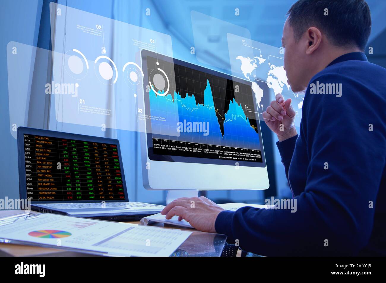 Business man looking into a modern computer screen deeply reviewing a financial report for a return on investment or investment risk analysis. Stock Photo