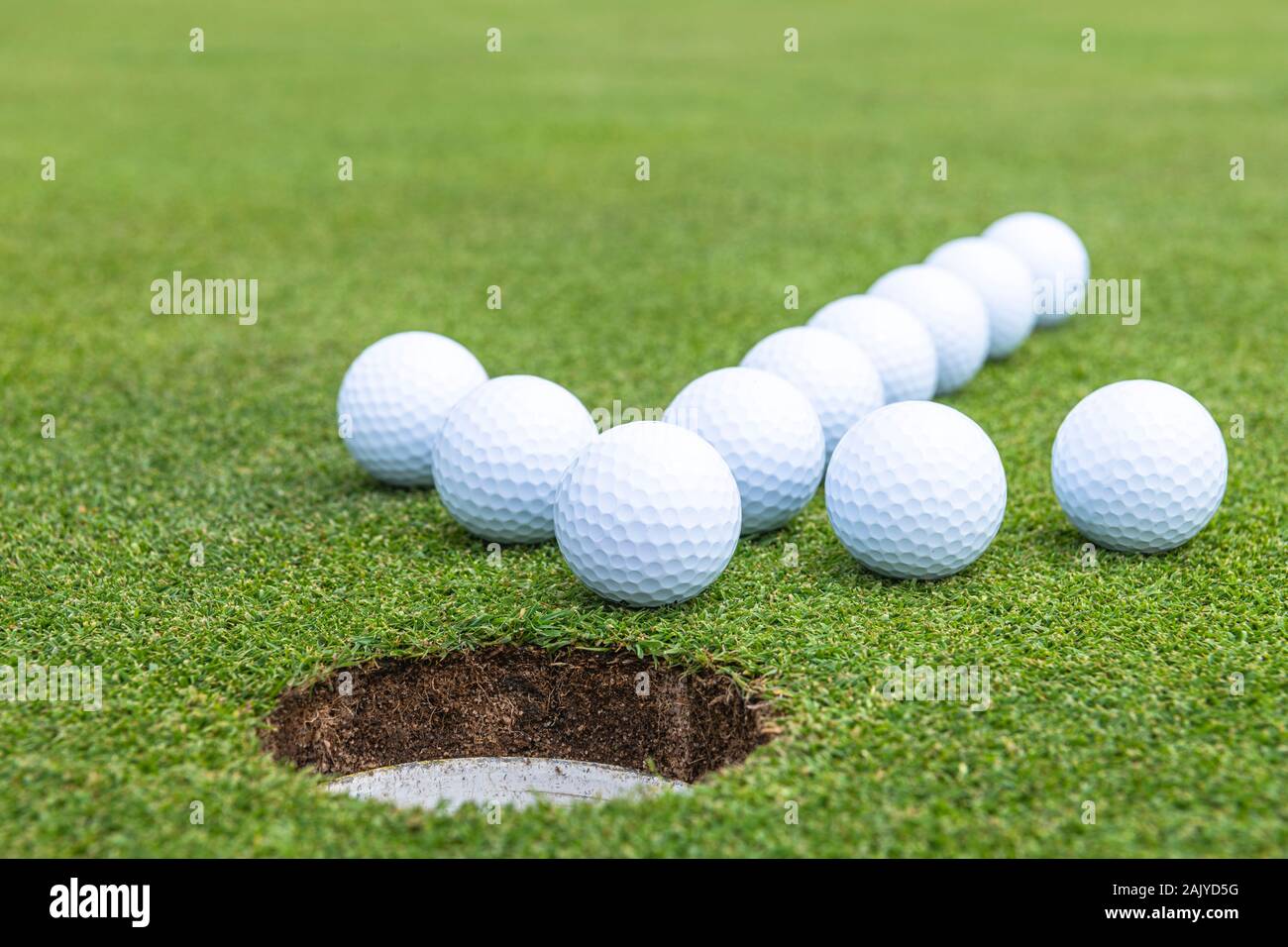 Primary goal of a golf game ball has to go into the hole Stock