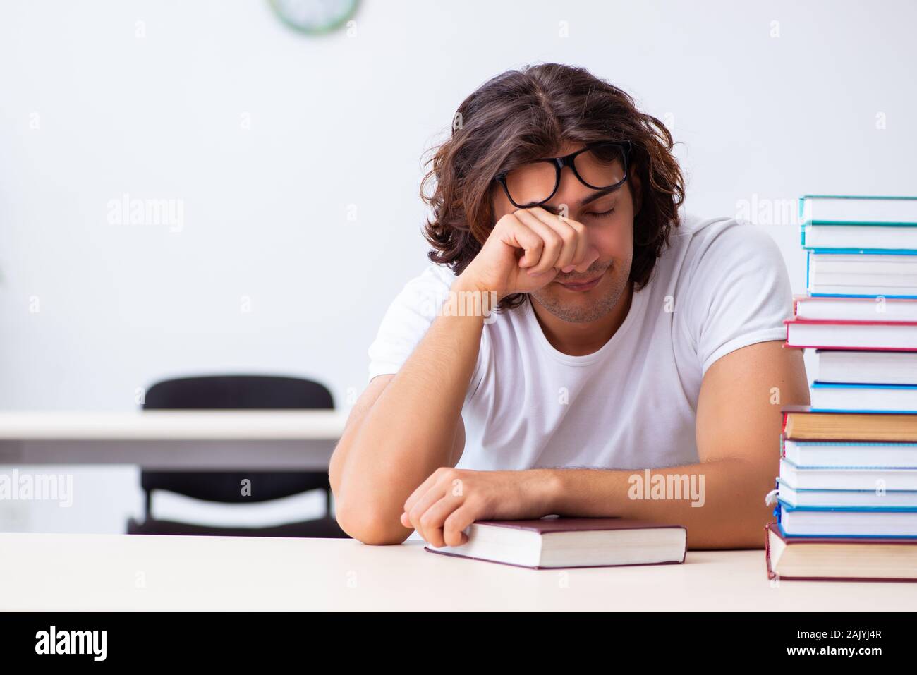 The young male student sitting in the classroom Stock Photo - Alamy