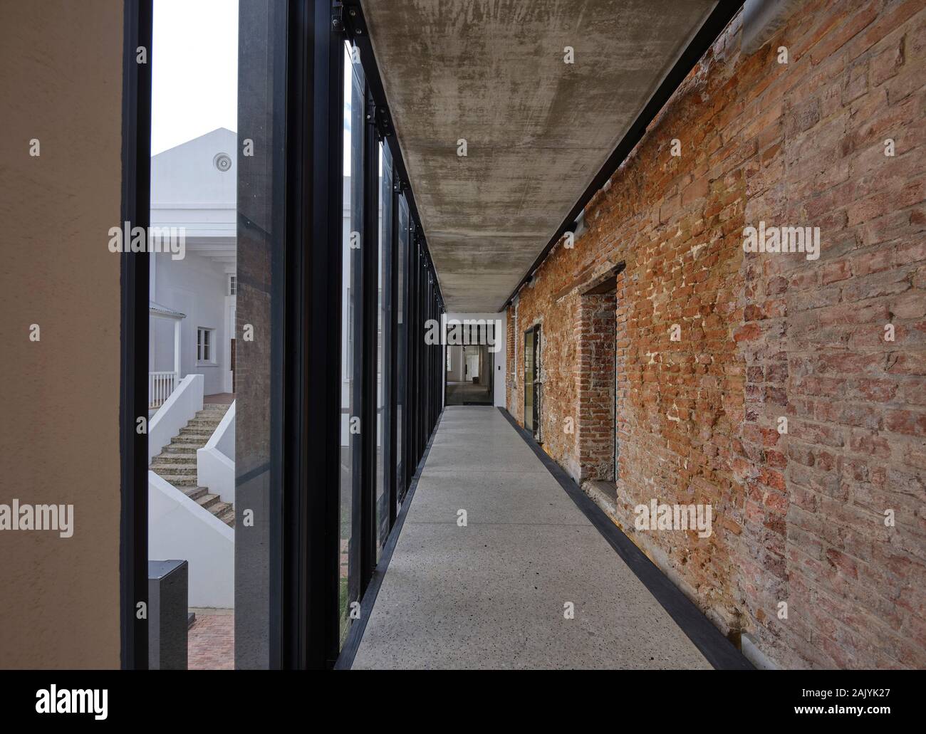 Corridor with exposed brick wall. Desmond & Leah Tutu Legacy Foundation, Cape Town, South Africa. Architect: Makeka Design Lab, 2019. Stock Photo